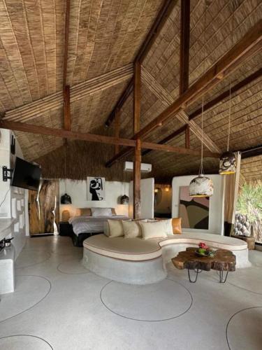 a living room with a couch and a table at Happy Coco Monkey - Cozy Studio by SP Villa in Ko Phangan