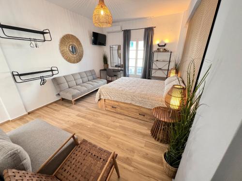 a living room with a bed and a couch at aeolian blu 1 in Parikia