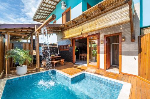 a house with a swimming pool and a patio at Village das Estações in Marau