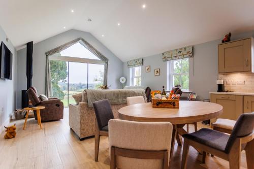 a kitchen and living room with a table and a couch at Whitehill House Farm Banbridge in Banbridge