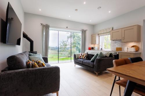 a living room with two couches and a table at Whitehill House Farm Banbridge in Banbridge
