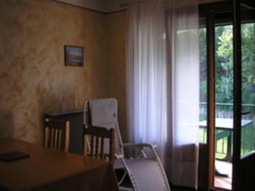a dining room with a table and chairs and a window at Sun Canigou in Vernet-les-Bains