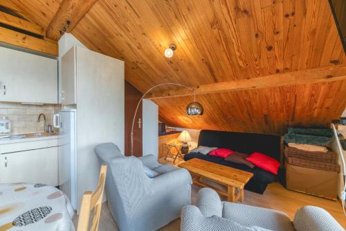 a living room with a couch and a table at La Meije 9 Appt 4p in Villard-Reculas