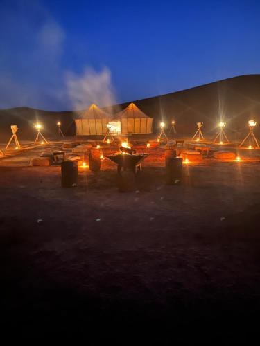 a plane is parked in a field at night at Across Sahara in Bou Nou