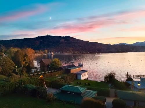 a view of a lake with a mountain in the background at Seeappartements Villa Sole in Pörtschach am Wörthersee