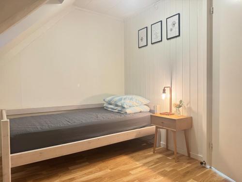 a small bedroom with a bed and a table at Large central townhouse, only 500m from Horsens city center in Horsens