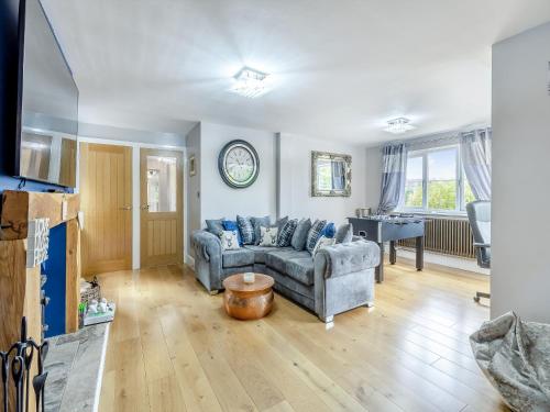 a living room with a couch and a table at Lovetts Bridge Cottage in Atherstone
