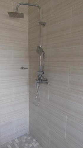 a shower with a shower head in a bathroom at Lilly Petals Guest House in Maun
