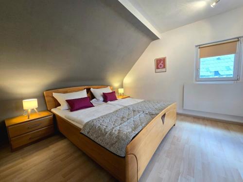 a bedroom with a large bed and a window at Ferienhäuschen in Dickesbach in Dickesbach