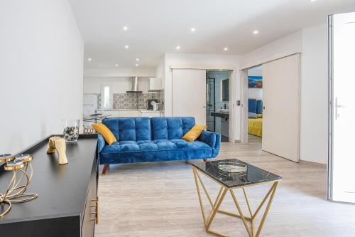 a living room with a blue couch and a table at Refúgio da Raia in Melgaço