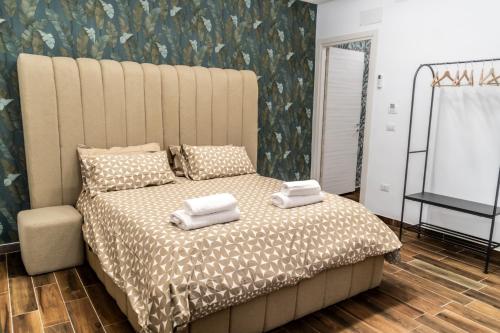 a bedroom with a large bed with towels on it at AP Apartment B&B in Bagnoli Irpino