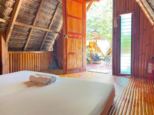 a bedroom with a bed with a towel on it at RCM Ecolodge Inn in San Juan