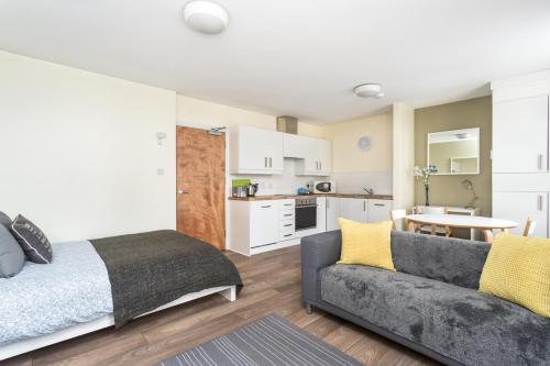 a living room with a bed and a couch at Walled City Apartments in Derry Londonderry