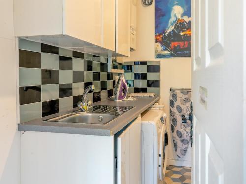 eine kleine Küche mit Spüle und Kühlschrank in der Unterkunft Forest View Cottage in Nottingham