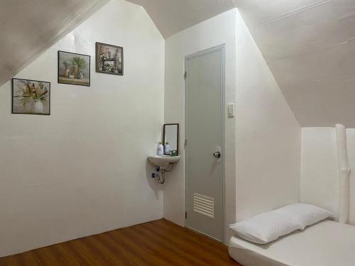 a white room with a white door and a toilet at RCM Ecolodge Inn in San Juan