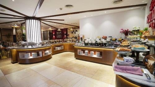 a restaurant with a buffet line with food on display at Best Western Plus Grand Multan in Multan
