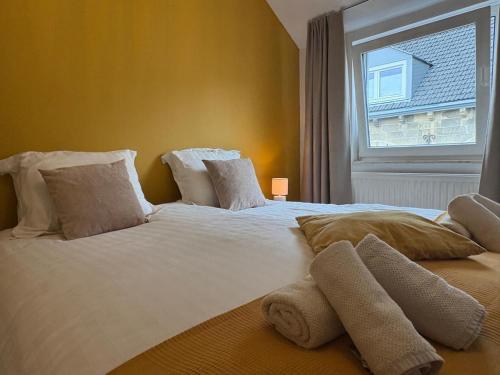 ファルケンブルグにあるBLESS Valkenburgの窓のある大きな白いベッドのある寝室