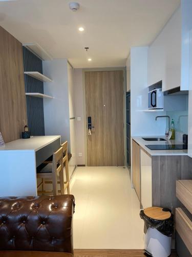 a kitchen and living room with a couch and a table at Once Pattaya Top Luxury Condo in the City Center in Pattaya Central