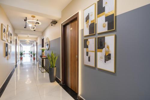 a hallway of a hospital with pictures on the walls at FabHotel Sri Karthikeya Grand - Nr Nexus Mall, Kukatpally in Hyderabad