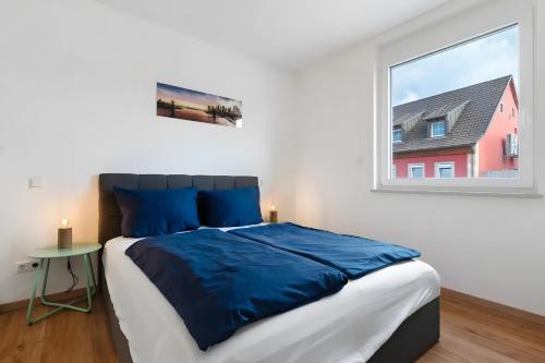 a bedroom with a large bed and a window at White House Apartments-App 1 und 2 in Kappel-Grafenhausen