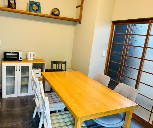 a dining room with a wooden table and chairs at Takemi no Yado - Vacation STAY 97130v in Yufuin