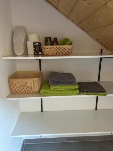 a room with shelves with towels and baskets on them at Holzliebe mit Donaublick in Kaisheim