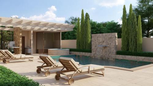 a group of chairs sitting next to a swimming pool at Solena in Camburi