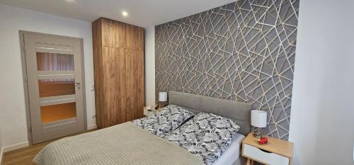 Ένα ή περισσότερα κρεβάτια σε δωμάτιο στο Apartament 9 Delux - Bliżej Zdroju