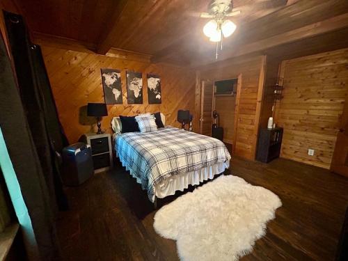 a bedroom with a bed and a white rug at Woodsy home near Wineries, Hiking, & River in Dahlonega
