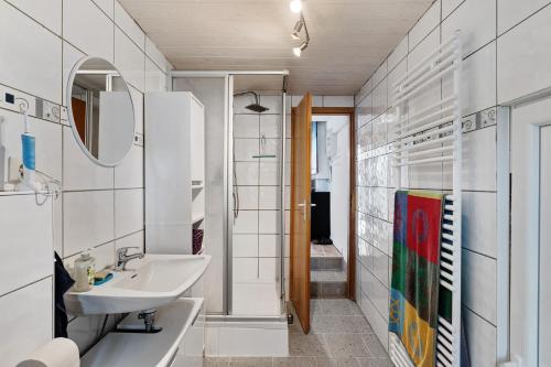 a bathroom with a sink and a mirror at Ferienwohnung Hagen in Pfalzgrafenweiler