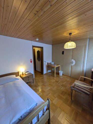 a bedroom with a bed and a wooden ceiling at Hotel St. Josefshaus Engelberg in Engelberg