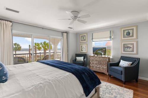 a bedroom with a bed and a view of the ocean at Ocean Front Escape - 1106 Beachview Dr in Demere Park