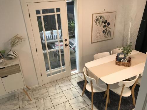 a dining room with a white table and chairs at Urban Oasis in Toronto
