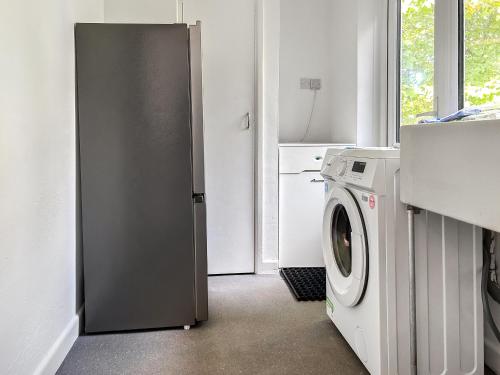 a kitchen with a refrigerator and a washing machine at Revita in Hale