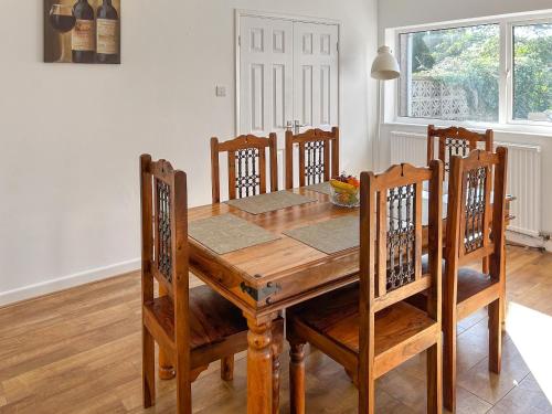 a dining room table with chairs and a wooden table at Revita in Egremont