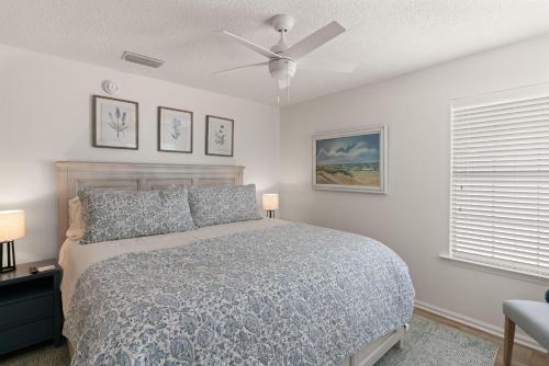 a bedroom with a bed and a ceiling fan at Point Five - 1133 Mallery St in Saint Simons Island