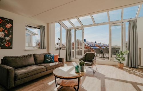 a living room with a couch and a table at Oostergeest 3 6P in Uitgeest