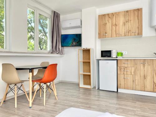 a kitchen and dining room with a table and chairs at Студия за нощувки - Стара Загора in Stara Zagora