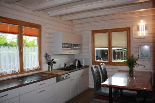 a kitchen with a table and a table and chairs at Ferienhaus Zuehlke in Groß Nemerow