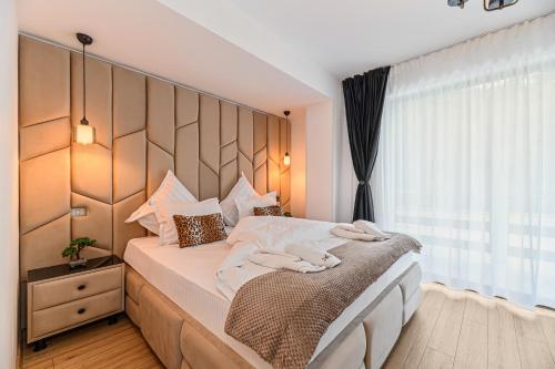 Postel nebo postele na pokoji v ubytování Ama Garden Spa Apartment Busteni