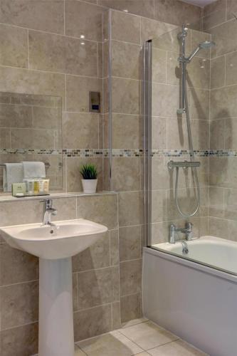 a bathroom with a sink and a tub and a shower at The Craiglands Hotel Sure Hotel Collection by Best Western in Ilkley