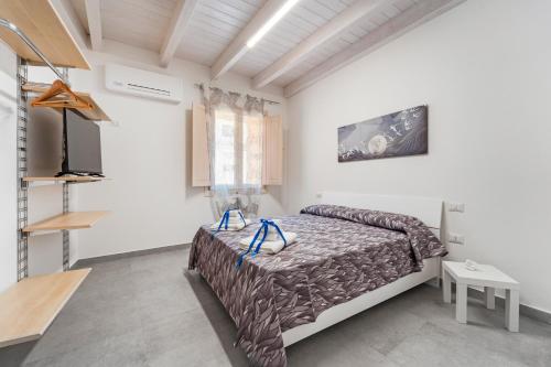 a bedroom with a bed in a white room at Casa Vacanze Sa Domixedda in Guspini