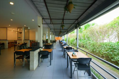 a restaurant with tables and chairs in a cafeteria at Tuana Hotels The Natural Resort in Patong Beach