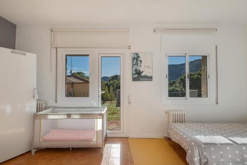 a white room with a bed and a window at Casa Marice in Premia de Dalt
