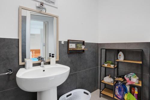 a bathroom with a white sink and a mirror at Montemare in Ameglia
