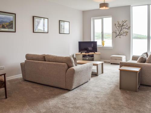 a living room with two couches and a tv at Gleaner Lea Apartment in Campbeltown