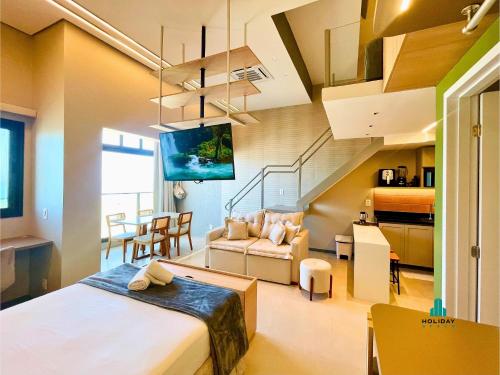 a bedroom with a bed and a living room at Beach Class Meireles by Holiday Stays in Fortaleza