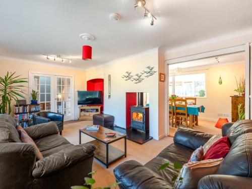 a living room with couches and a fire place at Applepips in Stirling