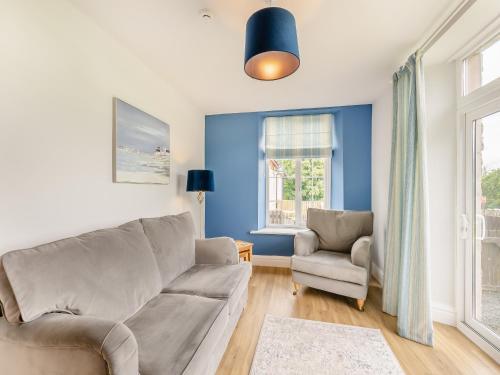 a living room with a couch and a chair at Arnside Apartment in Lindale