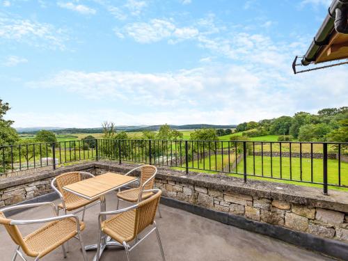 een patio met een tafel en stoelen en uitzicht bij Baycliff Apartment in Lindale